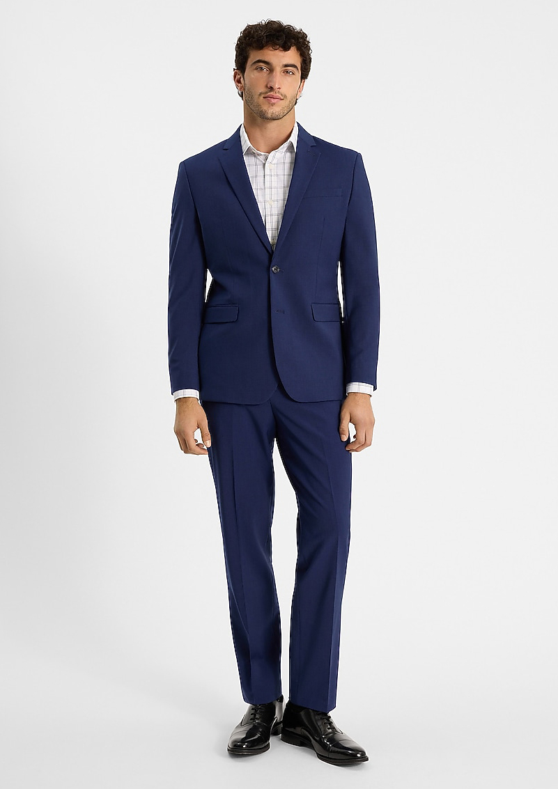 Model wears a navy classic-fit suit with a check dress shirt and black dress shoes