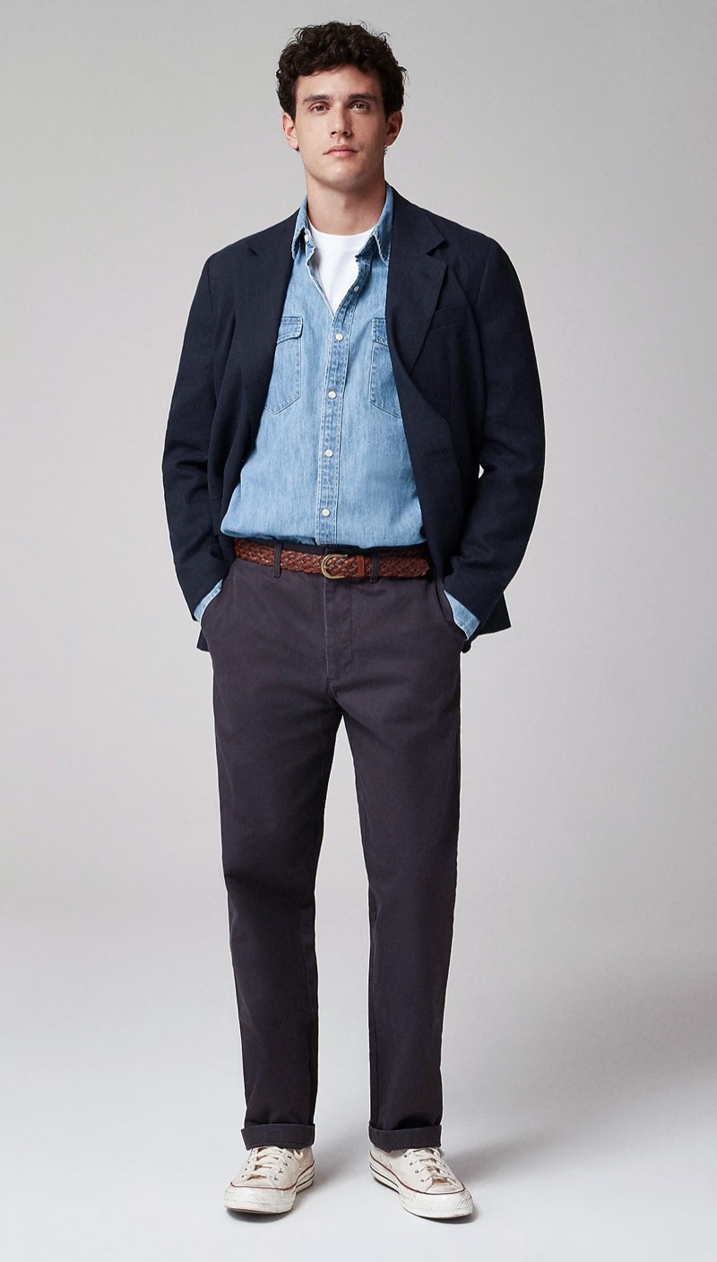 light blue denim shirt under black blazer with dark chinos and white sneakers outfit for men