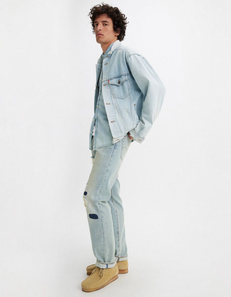 light wash denim shirt layered under denim jacket with relaxed fit jeans