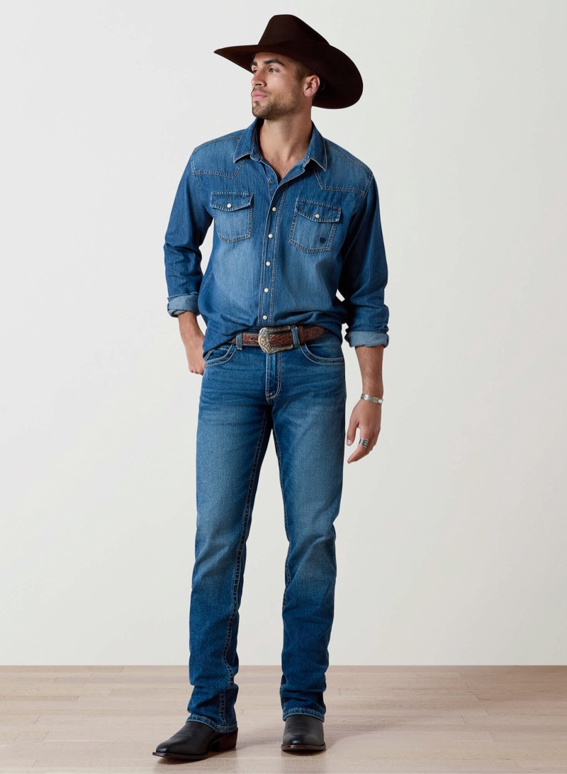 distressed western denim shirt tucked into jeans with cowboy hat and western boots
