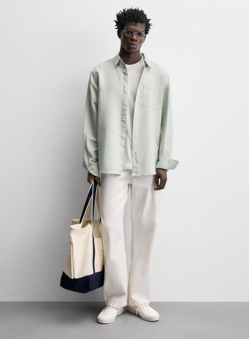 Model wears sage green linen shirt and ecru jeans outfit