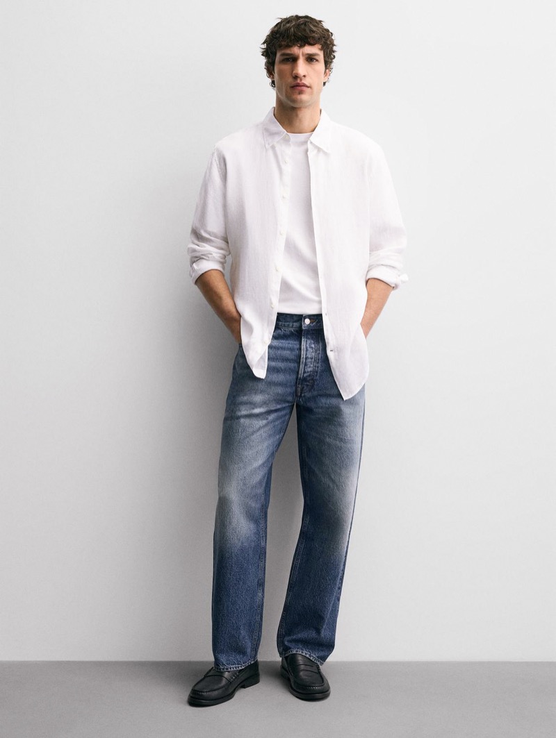 Model wears white linen shirt and jeans outfit
