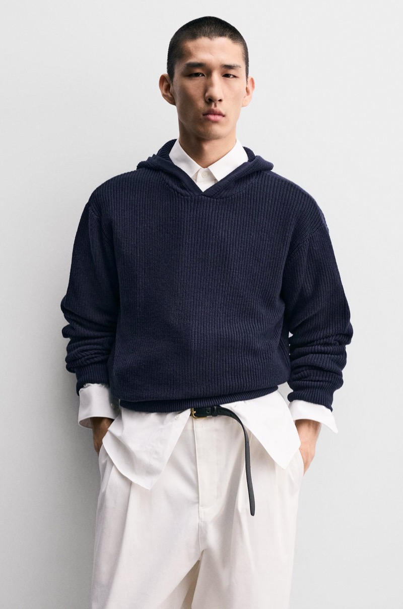 Navy ribbed hooded sweater layered over a white shirt