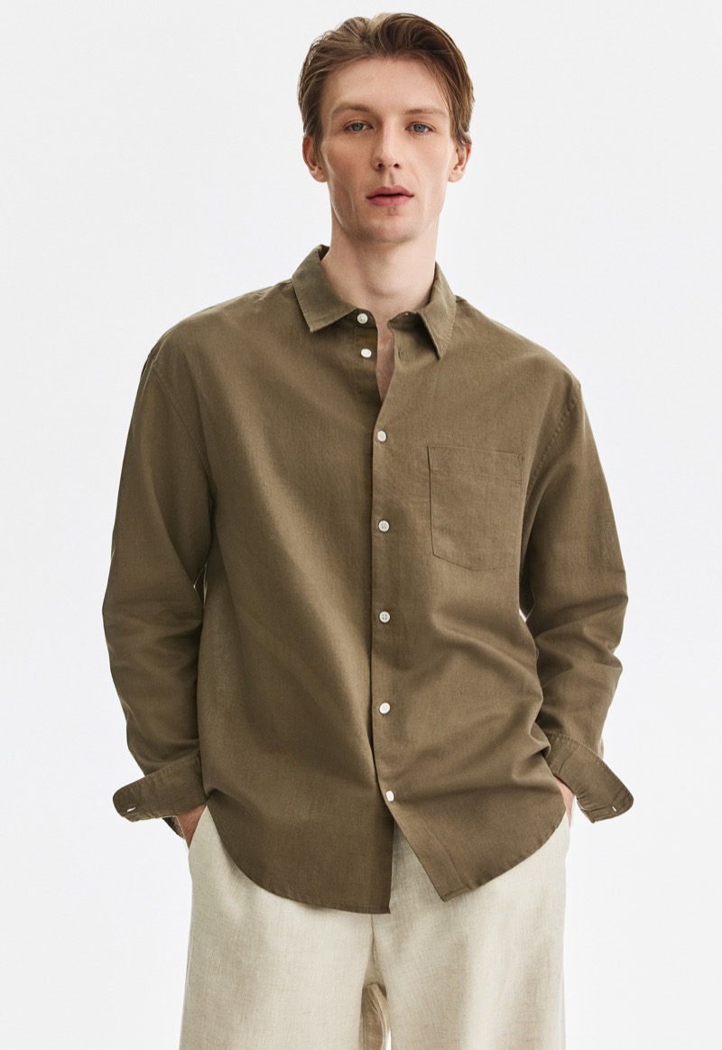 man wearing olive linen shirt with sleeves down