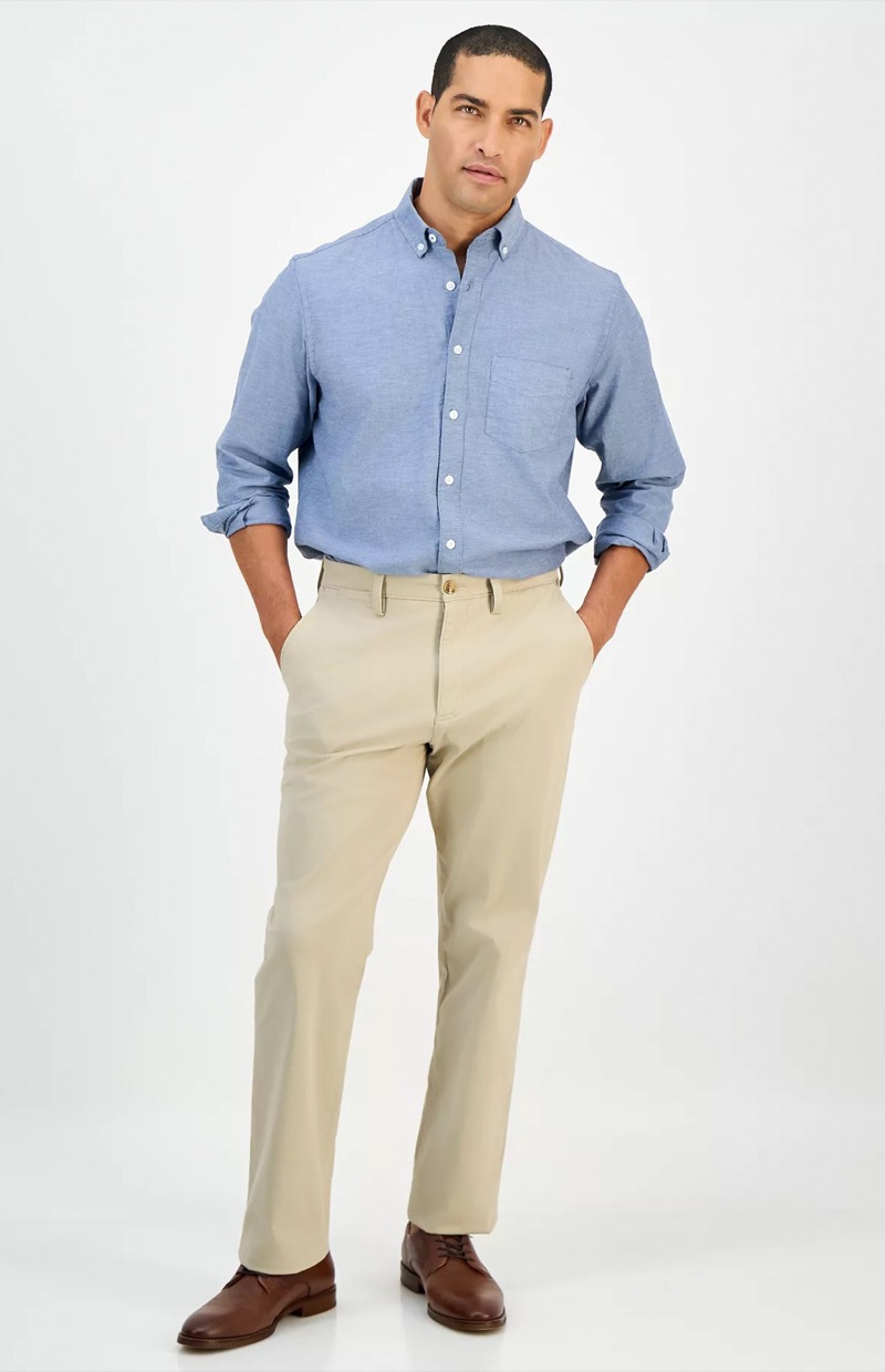 model wears blue oxford shirt with khakis and brown leather dress shoes