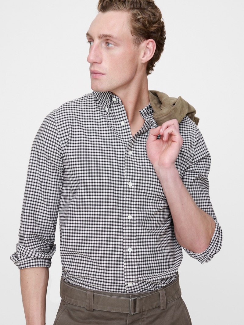 man wearing gingham check button-up shirt with sleeves rolled using the basic roll method