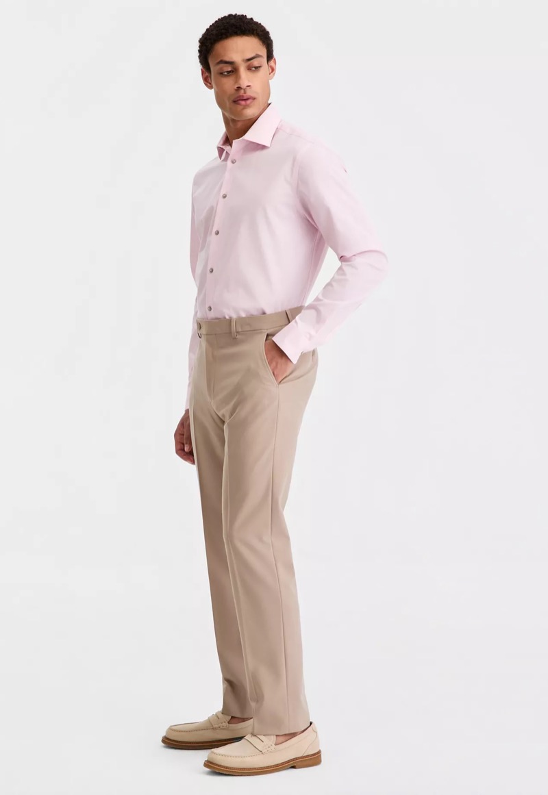 model wears pink dress shirt with khaki dress pants and tan suede loafers