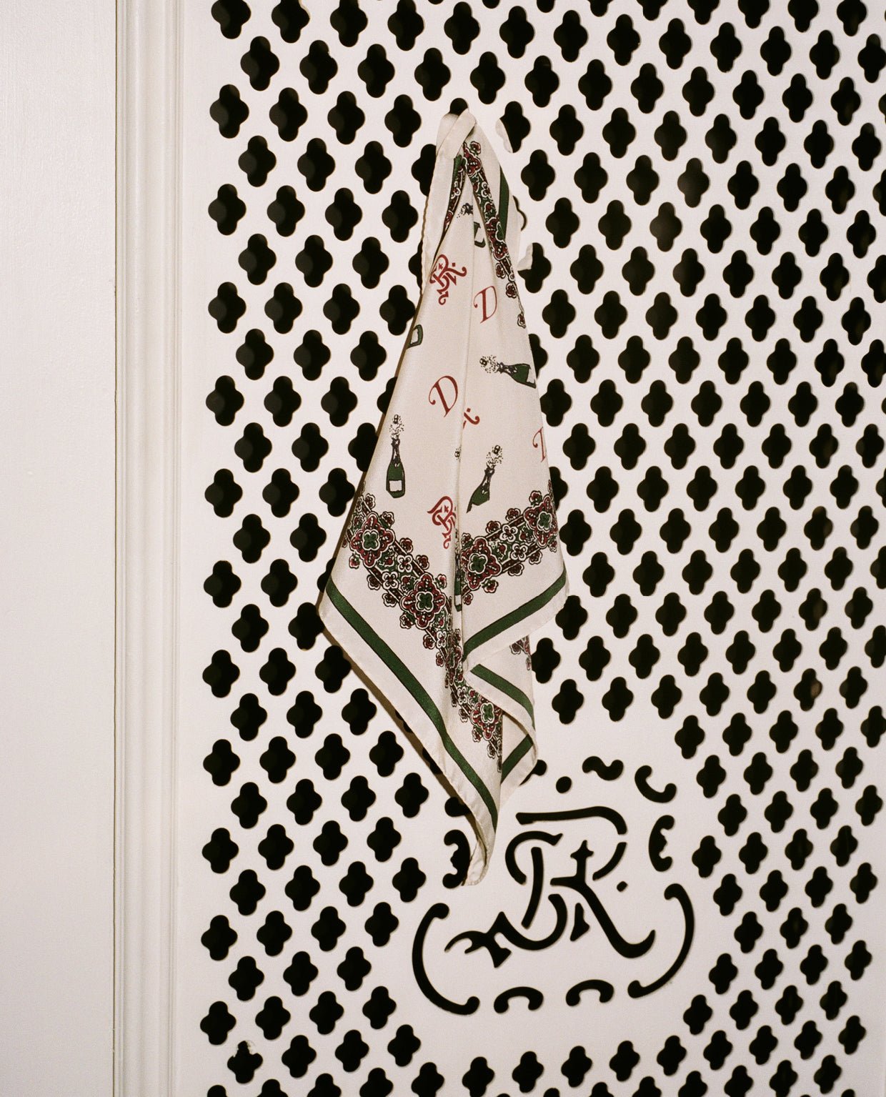 Champagne bottles decorate the collaboration’s silk pocket square.