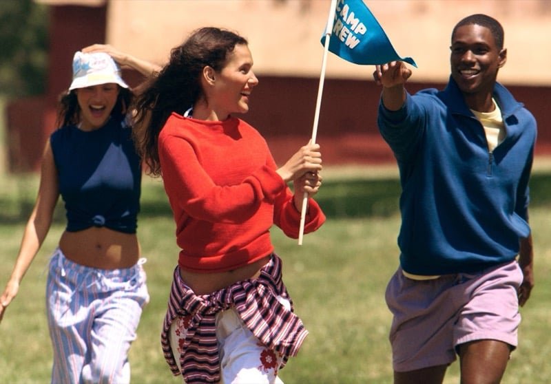 A blue quarter-zip and pale purple shorts join the action on the lawn.