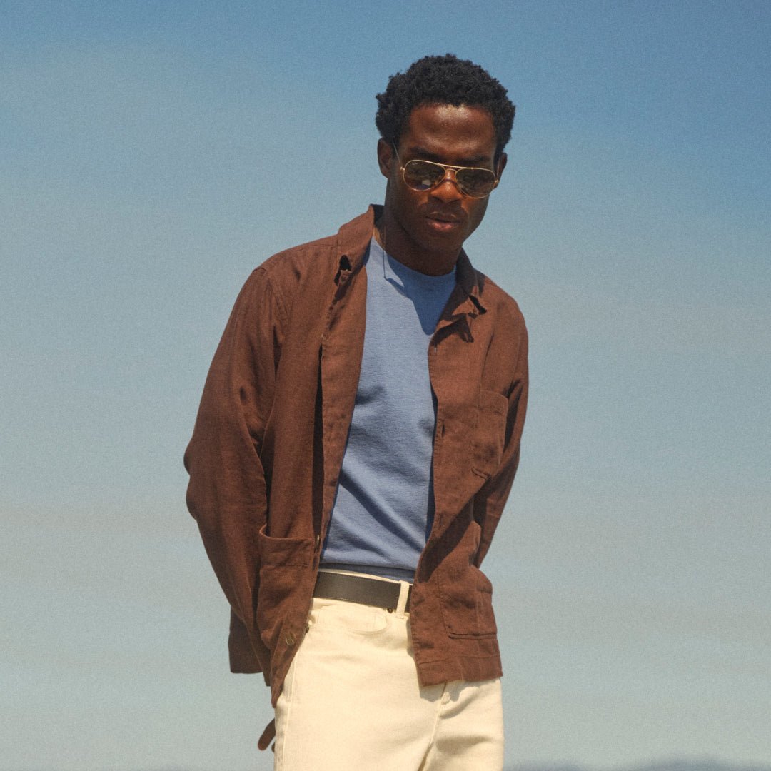 The brown Kimpton jacket brings a solid color to a blue tee and ecru jeans.