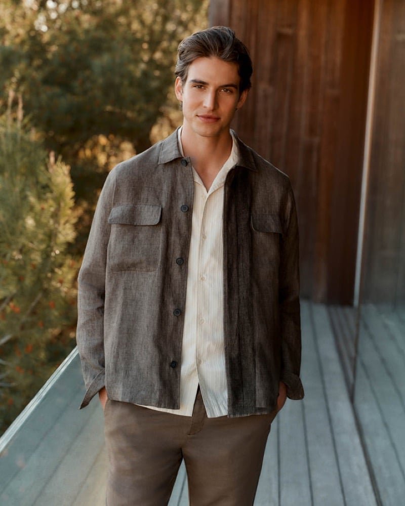 Valenti layers a brown linen overshirt over a cream shirt and taupe trousers.