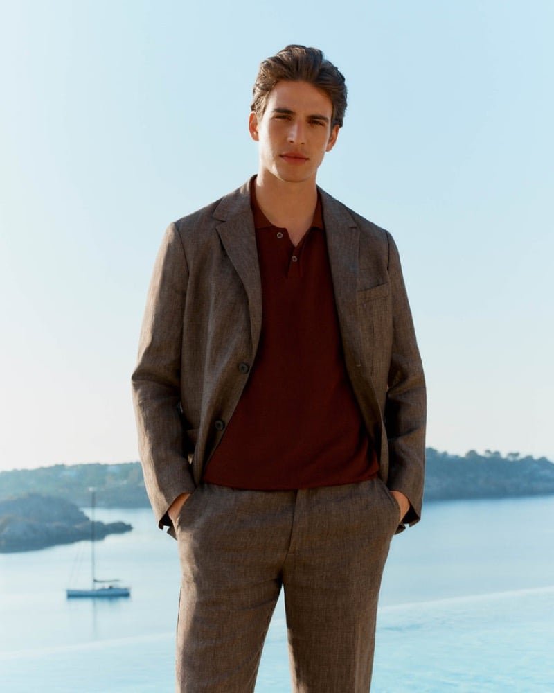 Brown linen tailoring frames a garnet polo.